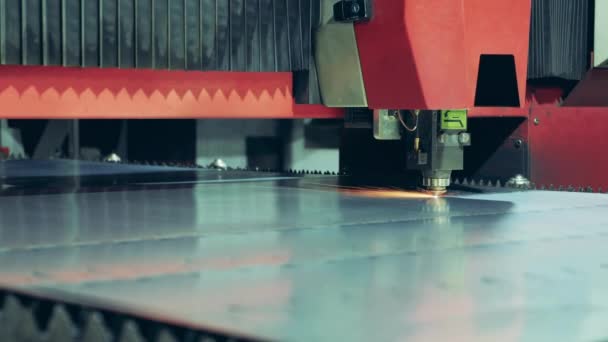 Factory machine is cutting a metal sheet with a laser — Stockvideo