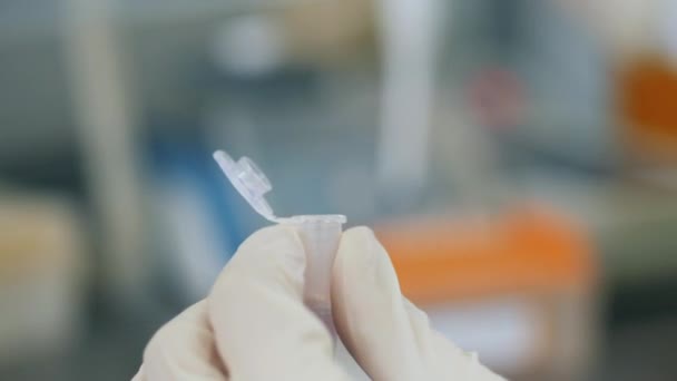 Gros plan d'une éprouvette entre les mains d'un expert de laboratoire — Video