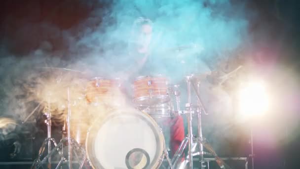 Professional musician is hitting drums and cymbals in clouds of smoke — Stock Video