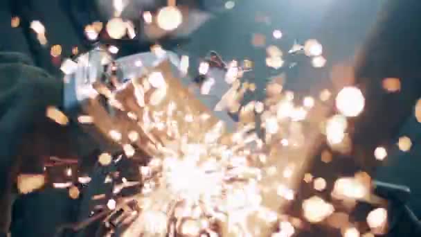 Metal is being cut and sparks are flying into the camera. Slow motion. — 비디오