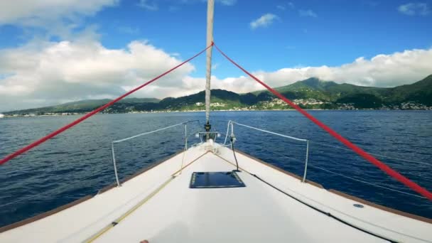 Sailing boats in blue ocean waters ina sunny day. First-person view from a boat sailing along the seaside — Stock Video