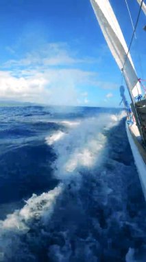 Upside-down view of blue waters getting crossed by a boat
