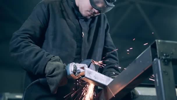 Male welder is cutting steel with a rotary saw — 비디오