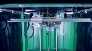 3D-printer head is creating a flat object