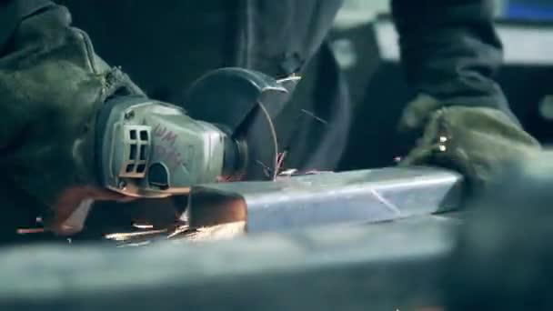 Welding technician is cutting iron beam with a saw — 图库视频影像