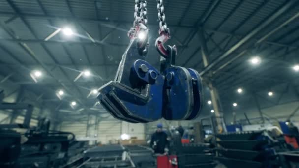 Clamping devices are hanging in a metalware plant unit — Stock Video