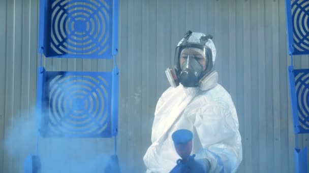 Female technician is using a spray gun to dye metal plates — 비디오