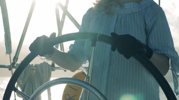 Sailing boat captain on her yacht. Ladys hands in gloves are holding a boats wheel — Stok video