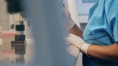 Woman works with medical tools in clinical laboratory.