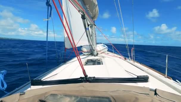 White sailing vehicle is rocking on the sea waves. Sailing boat, yacht sailing on opened sea. — Stock Video