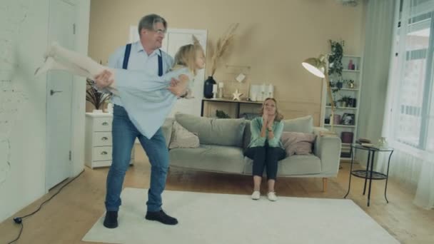 Grandfather and grandmother are having fun with a little girl — Stok video