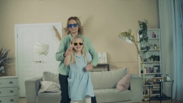 Grandma and her granddaughter are happily dancing together — Αρχείο Βίντεο