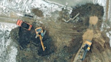 Modern tractors work at a quarry, digging earth. Construction excavator work at the industrial quarry.