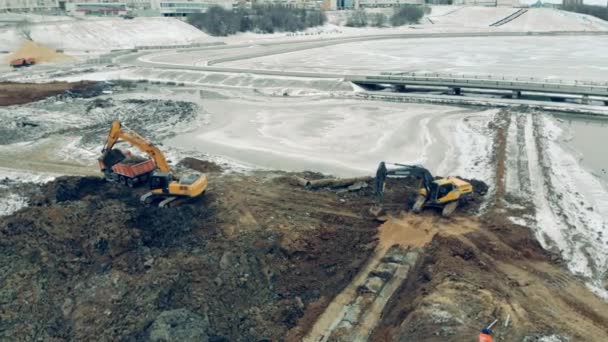 Yellow excavator work at a quarry, digging earth. — ストック動画