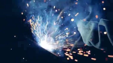 Man works with welding machine at a plant.