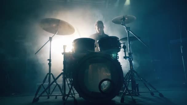 록 스튜디오에 있는 남자가 드럼을 연습하고 있어. 드럼 세트, 드럼 키트어두운 곳에서 드럼 연주자는 콘서트를 한다. — 비디오
