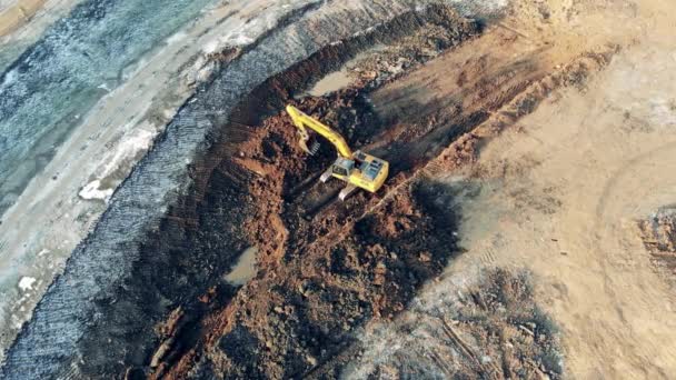 Top view of a digging vehicle working in the borrow pit Building, construction process. — Stock Video