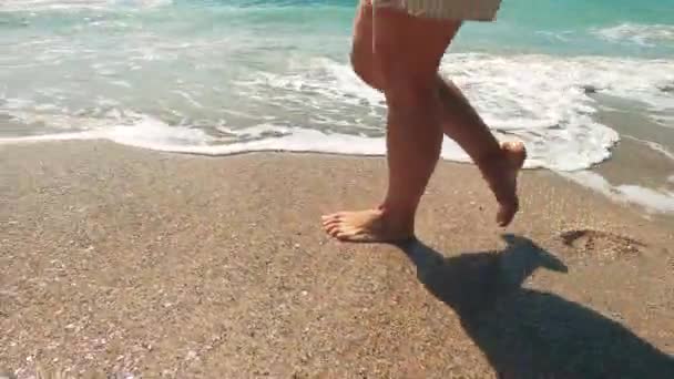 Женские ноги во время прогулки вдоль берега океана — стоковое видео