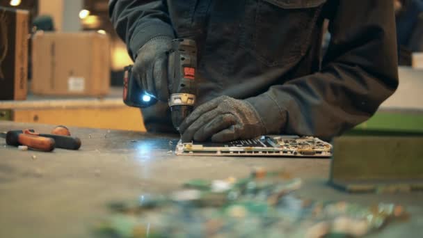 Close up of a screwgun being used to dismantle a laptop — Stock Video