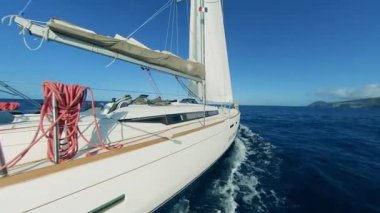 Side view of a vessel sailing towards the coast