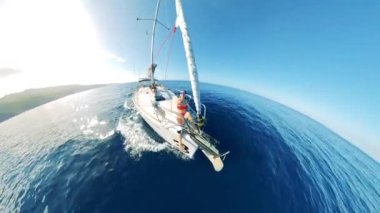 Semi-circle panorama of a yacht with a lady onboard crossing the sea