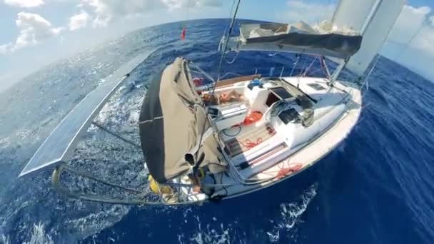 Sailing vessel with people is being led through the sea — Stockvideo