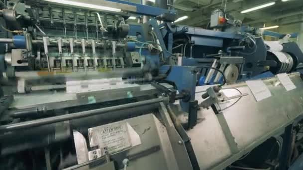 Paper pages are moving through a binding conveyor — Stock Video