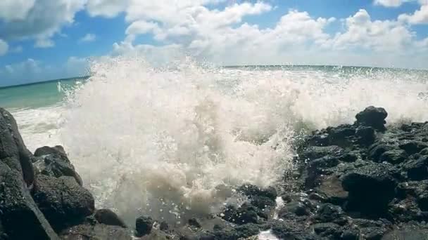 Rocky coast with waves washing over it in slow motion — Stok Video