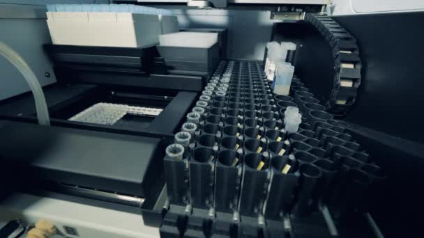 Medical device is putting biological samples into tubes — Stock Video