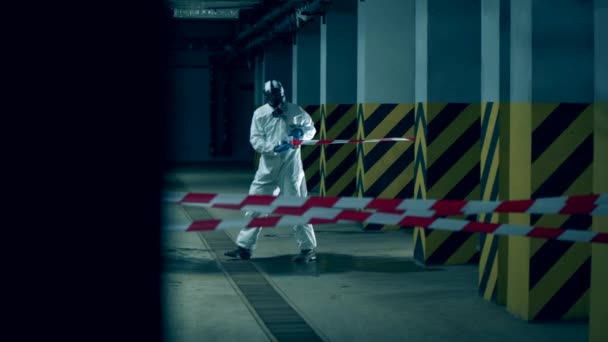 Coronavirus, Disinfection concept. Sanitation worker is stretching a barrier tape — Stock Video