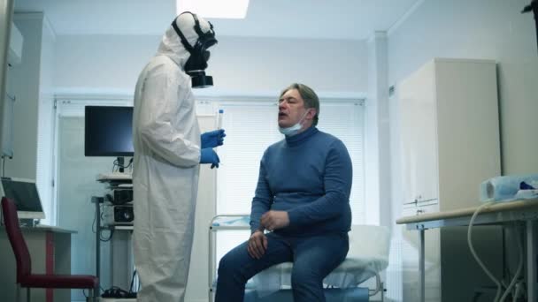Il dottore sta prendendo un tampone sulla bocca di un paziente anziano. Covid-19, pandemia, virus, malattia coronavirica, epidemia mondiale, concetto di infezione coronavirica . — Video Stock