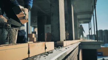 İşçiler bir proje sitesinde duvarcılık yapıyorlar. İnşaat işçisi inşaat alanında..