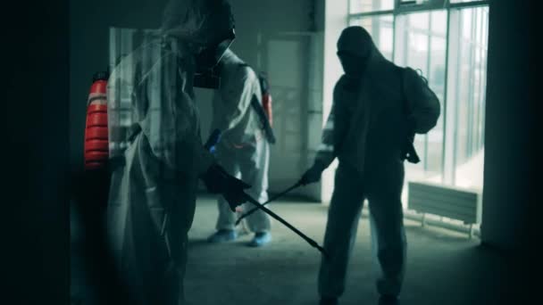 Coronavirus pandemic, virus prevention, COVID-19 concept. Sanitation workers are spraying disinfectant in empty premises — Stock Video