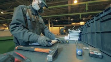 Erkek işçi onu sökmeden önce bir dizüstü bilgisayarı açıyor.