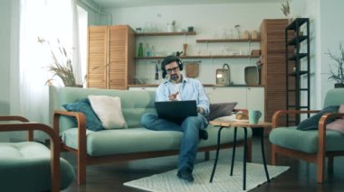Bir iş adamı karantinadayken bilgisayarla evden çalışır..