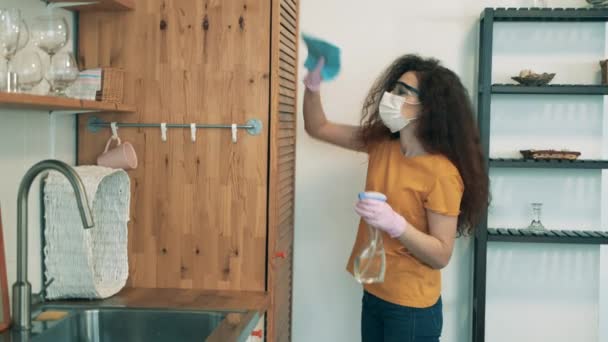 Egy nő fertőtleníti a ruhásszekrényét a lakásában. COVID-19 lezárási koncepció. — Stock videók