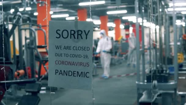 Anuncio de cierre en las puertas de un gimnasio durante el saneamiento — Vídeo de stock