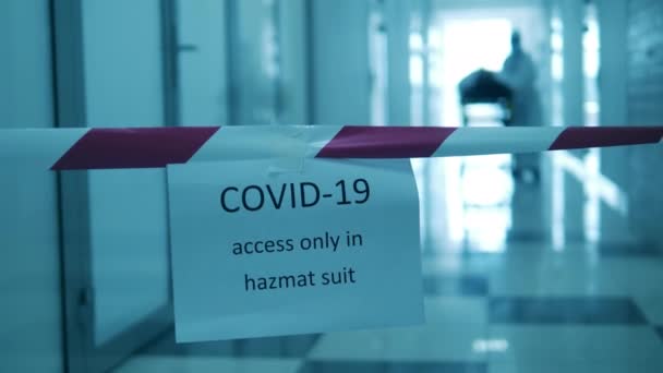 Пациент COVID-19 в коронавирусной больнице. Доктор перевозит пациента по карантинному коридору. — стоковое видео