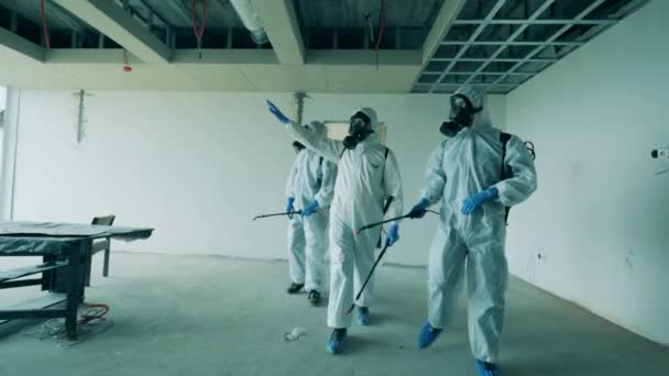 Werknemers controleren onafgewerkt gebouw alvorens het te desinfecteren. — Stockvideo