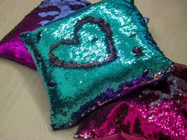 Heart on a pillowcase with sequins.