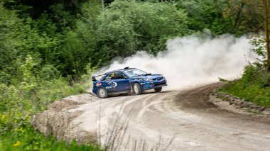 Rally drivers take a part in rally racing on subaru near the city Kamyanets-Podilsky, Ukraine, 10 of May 2019. Horizontal orientation.  clipart