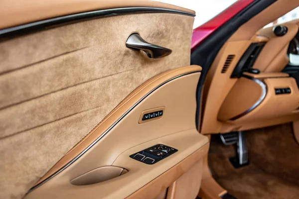 Beige car interior with black buttons on the door. Close-up. Horizontal orientation. — Stock Photo, Image