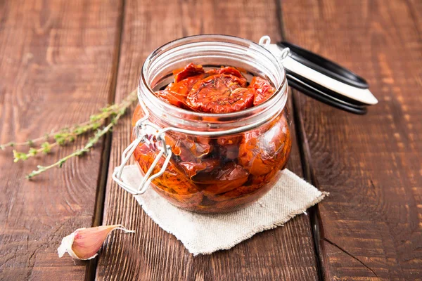 Zongedroogde tomaten met kruiden en zeezout in olijfolie in een gla — Stockfoto