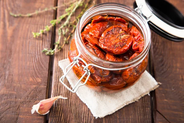 Zongedroogde tomaten met kruiden en zeezout in olijfolie in een gla — Stockfoto