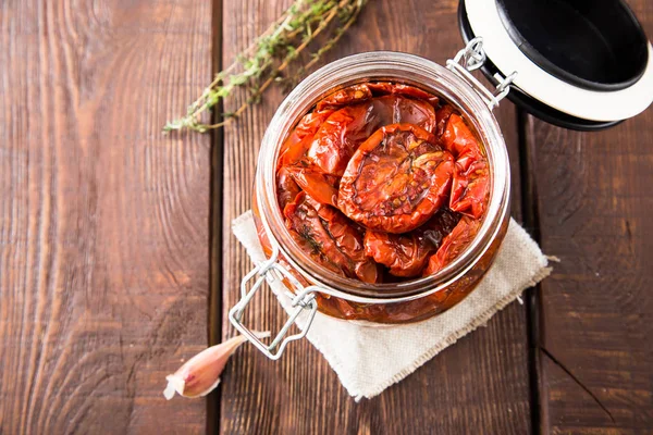 Zongedroogde tomaten met kruiden en zeezout in olijfolie in een gla — Stockfoto