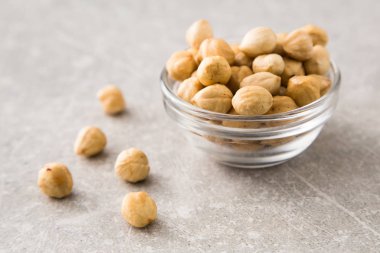 taş masada cam kase içinde kavrulmuş fındık