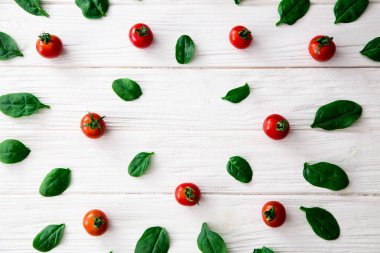 Ispanak ve kiraz domates çerçeve beyaz zemin üzerine yeşil yaprakları