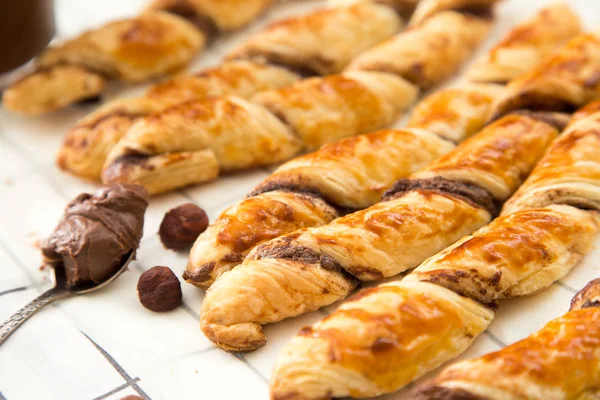 homemade cakes - puff pastry with chocolate paste. twisted cakes