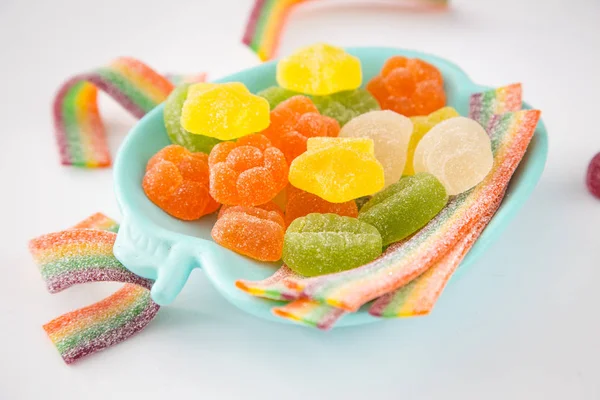 Candy background. Colorful candies in plate on light background — Stock Photo, Image