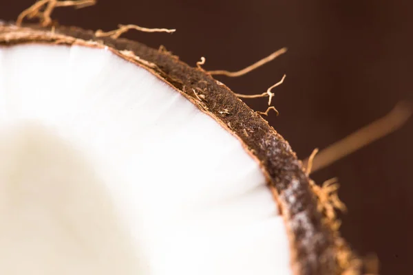 Metade do coco maduro sobre fundo de madeira — Fotografia de Stock